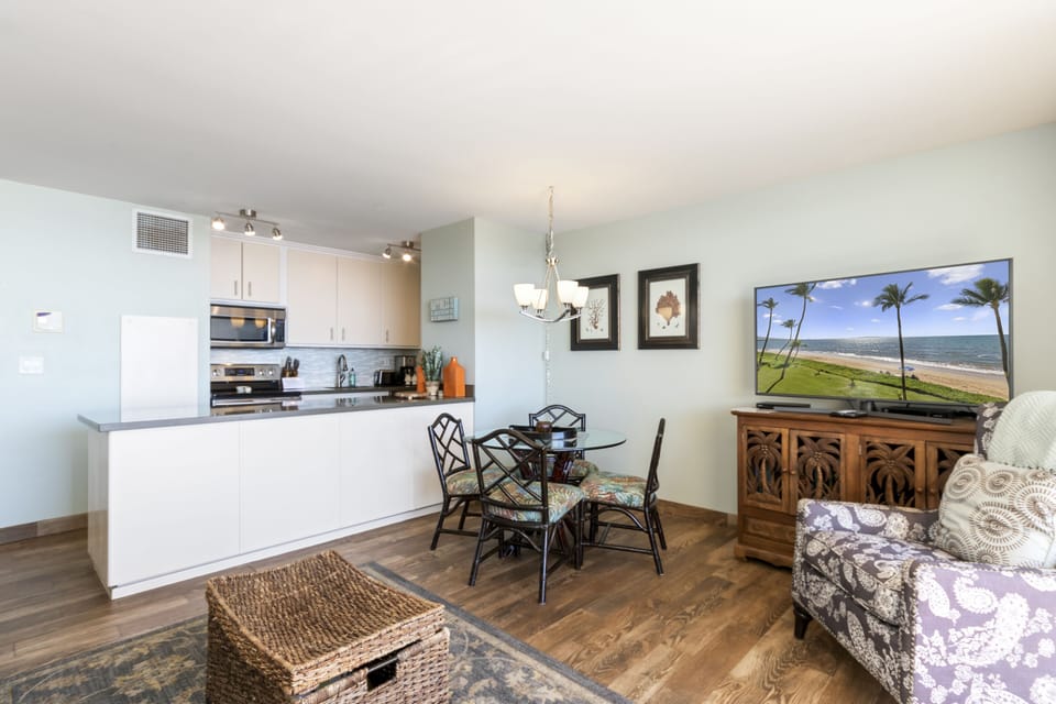 Your bright, open-plan living space features a fully equipped kitchen, cozy dining nook, and relaxing lounge—all bathed in natural light for the perfect vacation retreat.