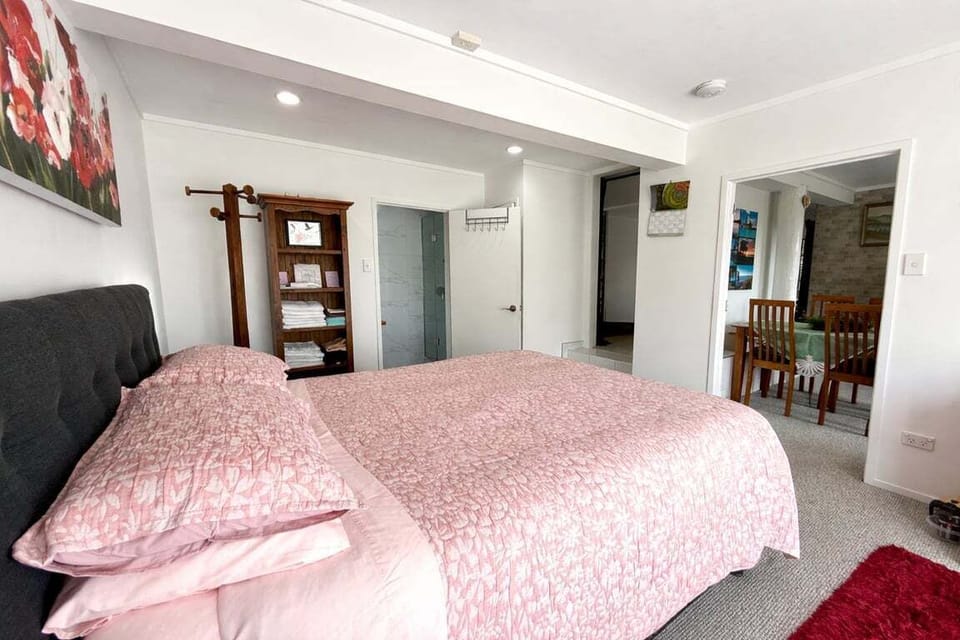 Generous downstairs bedroom with plush bedding and a peaceful vibe