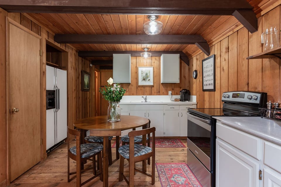 Open kitchen area with Keurig and space efficient dining table.