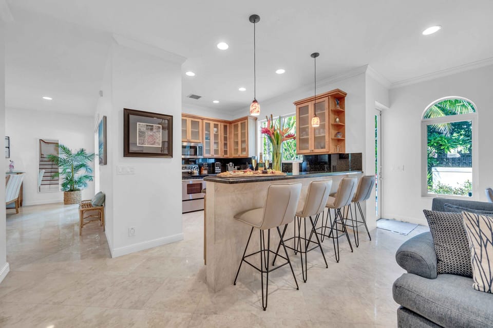 On the other side of the breakfast bar is the second, smaller living area. This living space has a comfy sofa and another wall mounted Smart T.V.