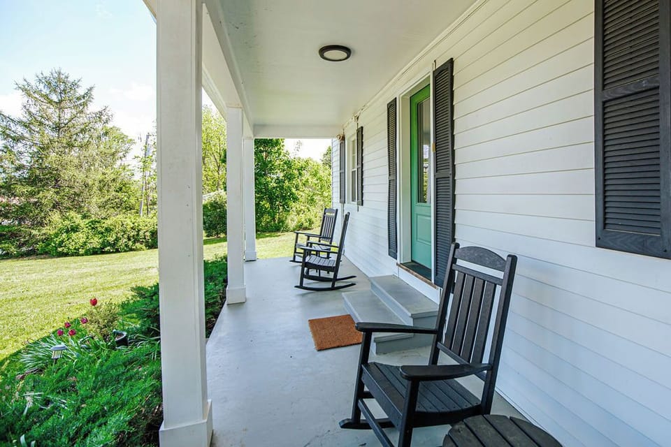 Guests enjoy drinking coffee on the front porch.