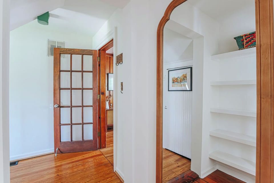 Large mirror at bathroom entry.