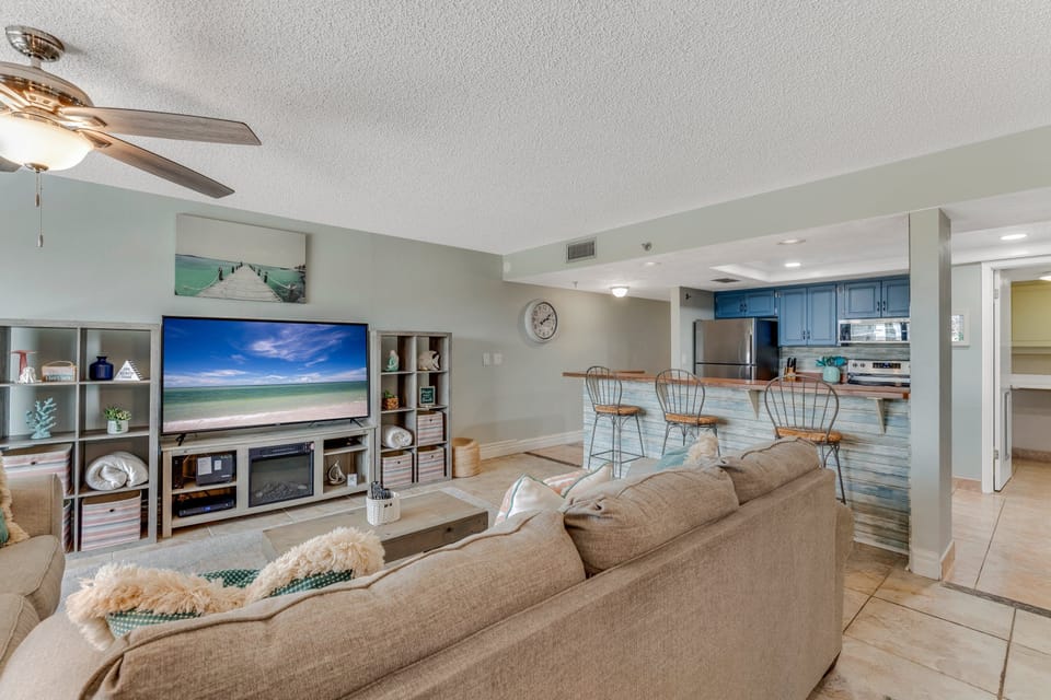 Relax in the comfortable living room, beautifully decorated with beachy coastal accents for a cozy, seaside vibe