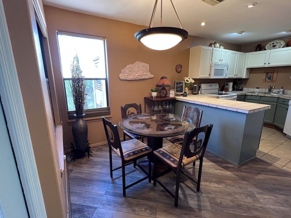 Copper and southwest patterned dining table with adjacent bar area