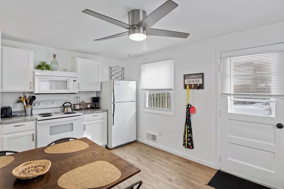 Fully stocked kitchen with all the cooking essentials, complemented by a beautiful dining table for the perfect meal experience