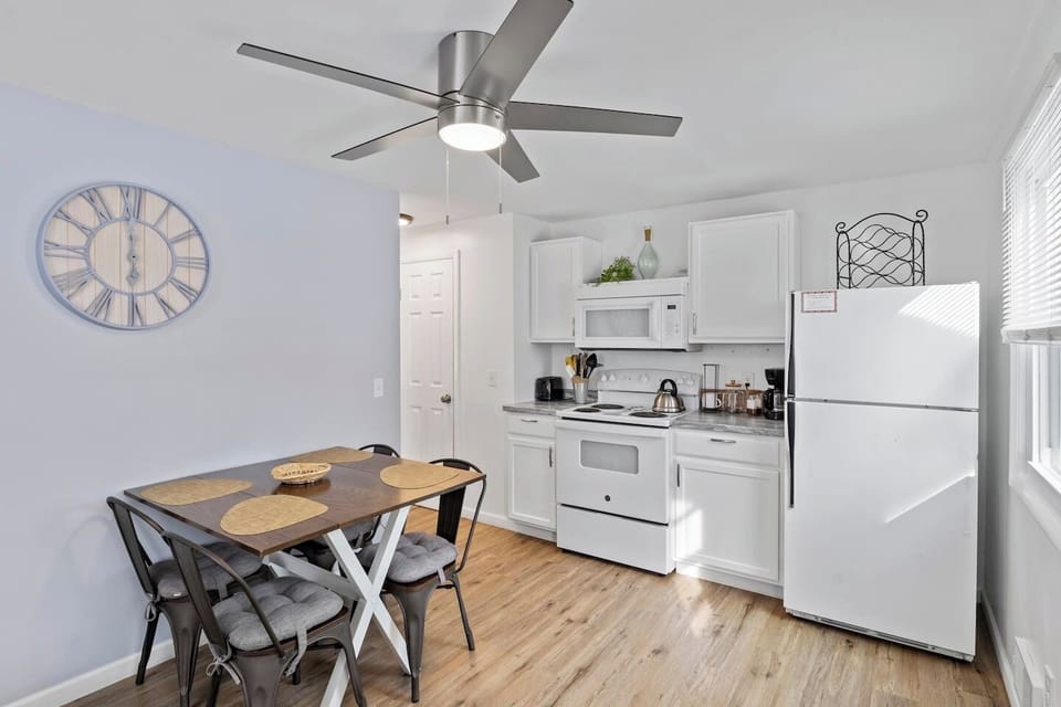 Fully stocked kitchen with all the cooking essentials, complemented by a beautiful dining table for the perfect meal experience