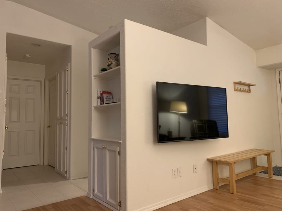 Living room looking toward bathroom and bedroom doors