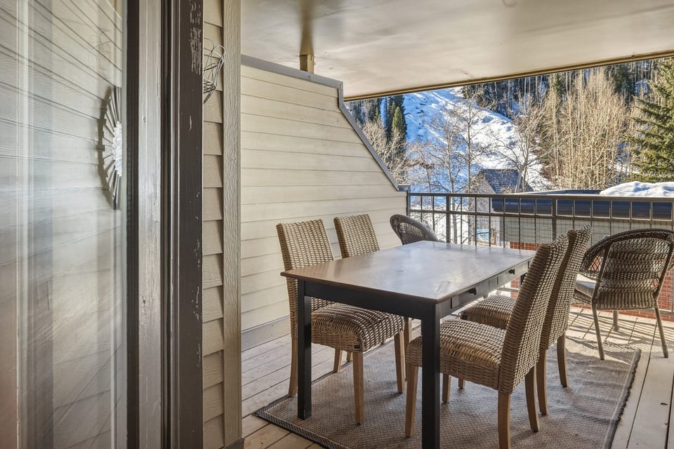 The partially covered deck off the primary bedroom is ideal for morning coffee, evening meals, or enjoying a sunset happy hour with mountain views.