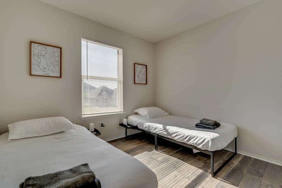 Bright and inviting, this twin bedroom offers a simple yet cozy retreat. Perfect for friends or family, it provides comfortable beds, fresh linens, and a peaceful atmosphere for a restful night.