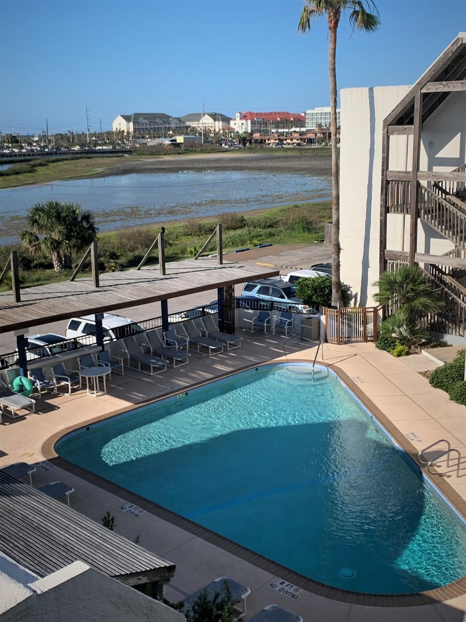 View of Pool from Condo Stairwell