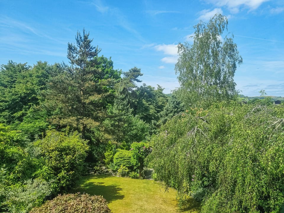 View of the garden from the balcony | Harwood Dale Cottage, Kendal