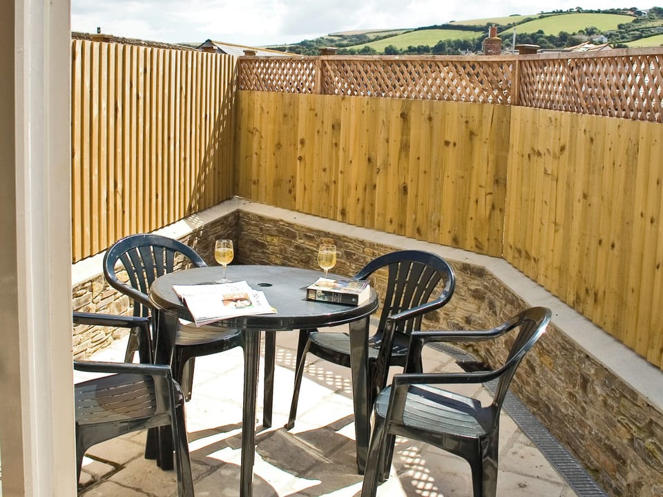 Rear patio with outdoor furniture and drying area | Retreat Cottage, Salcombe