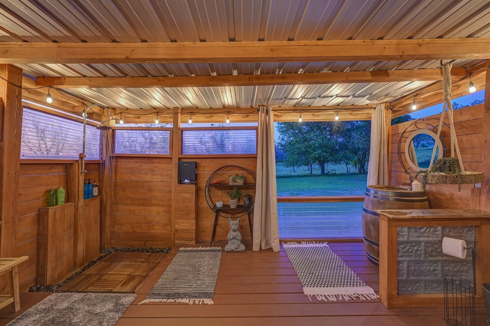 This is a one of a kind heated outside shower with open view to nature, and of course a curtain if you are shy.