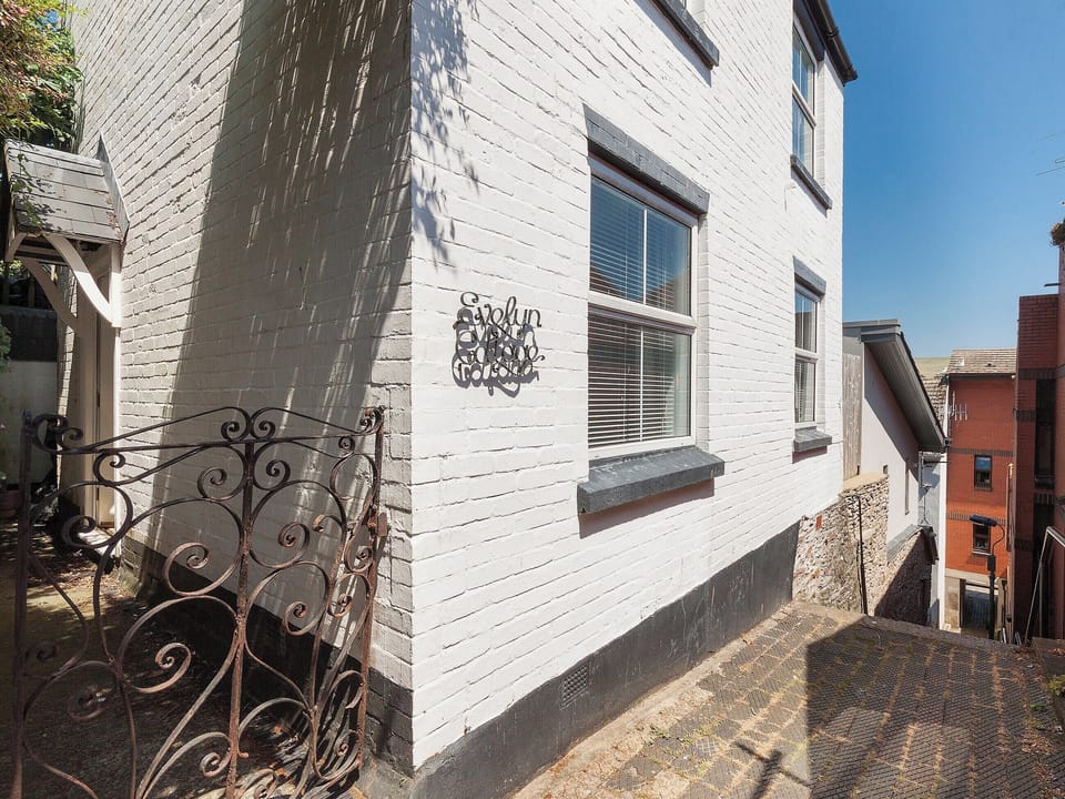 Whitewashed exterior with decking in the garden | Evelyn Cottage, Dartmouth