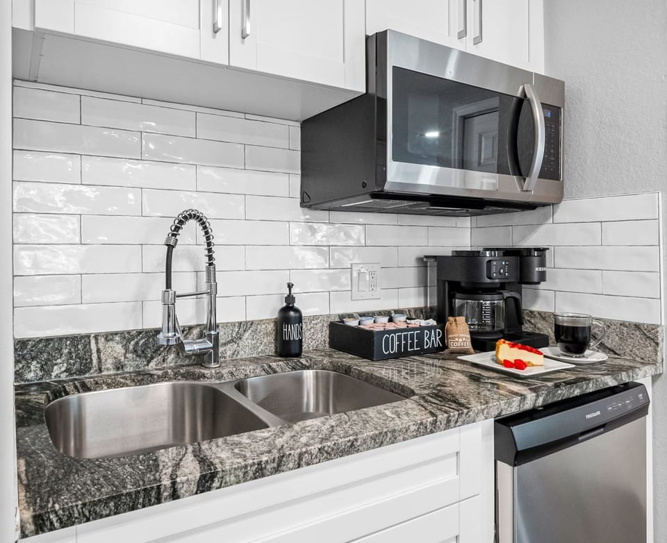 Enjoy the combination of sophisticated design and practical amenities in this modern kitchen space.
