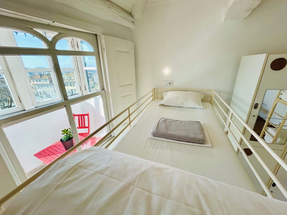 Bed in 8-Bed Mixed Dormitory Room with Shared Bathroom | Blackout drapes, iron/ironing board, free WiFi, bed sheets