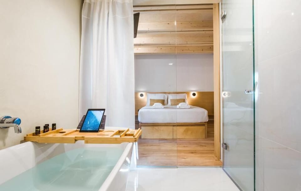 Deluxe Suite, Bath, Ground Floor | Desk, soundproofing, free WiFi, bed sheets