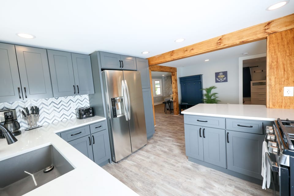 Kitchen with brand-new stainless steel appliances and granite countertops.