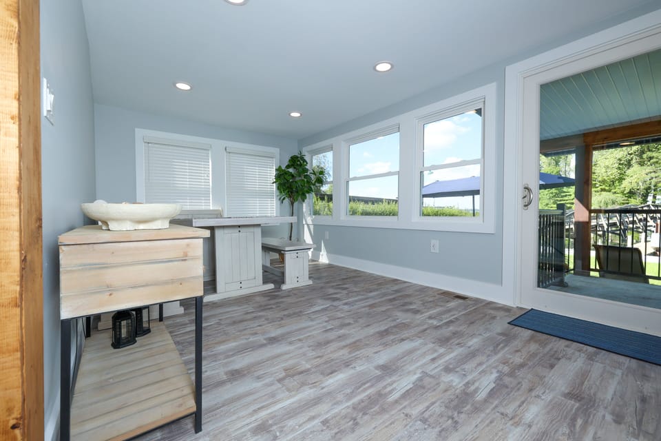 The dining table features bench seating with views of the lake.