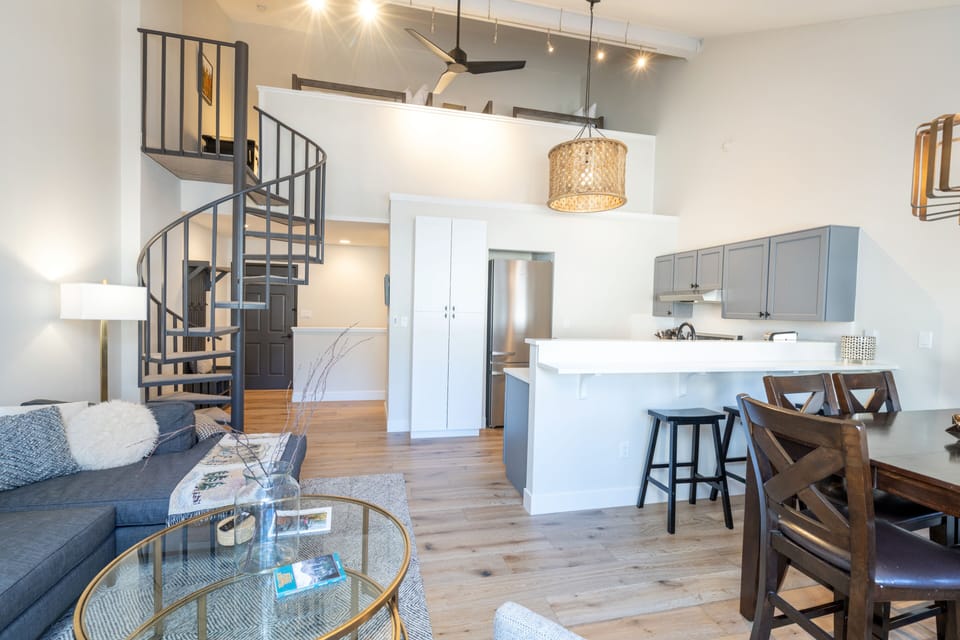 Open, bright living area with loft above
