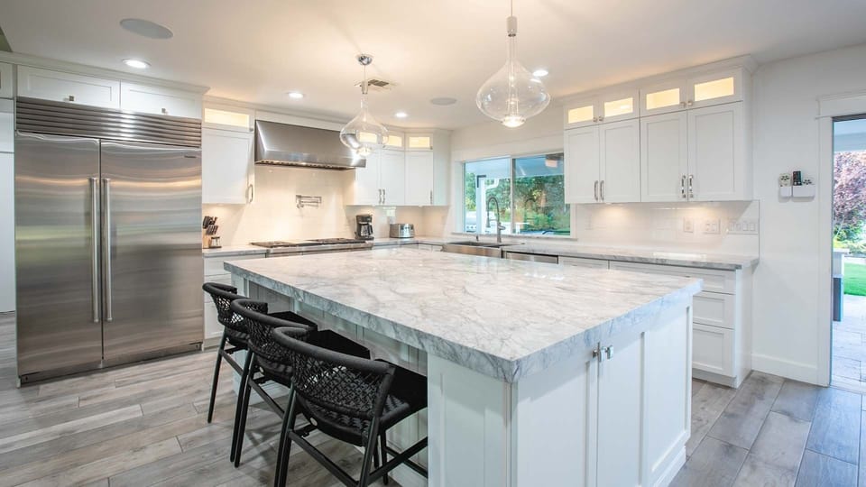 Modern kitchen featuring high end appliances w/ large island & seating