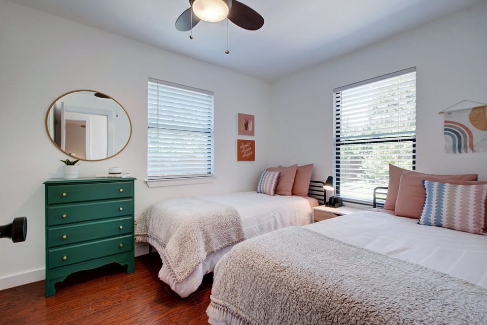 Second bedroom features abundant sunlight, two comfy twin beds and ample storage