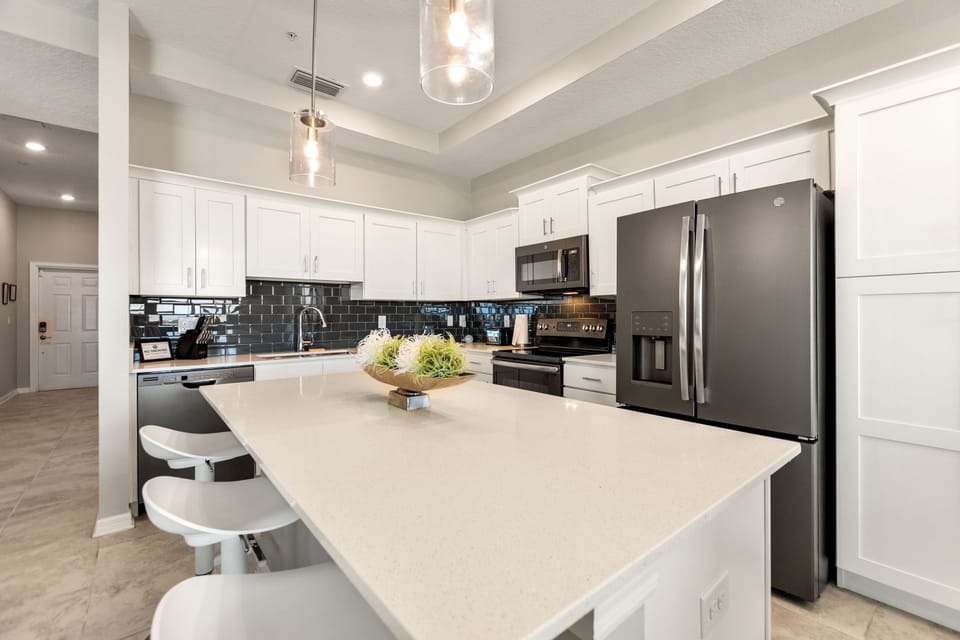 The kitchen is fully-equipped with modern features and with a bar height seating at the counter for 3