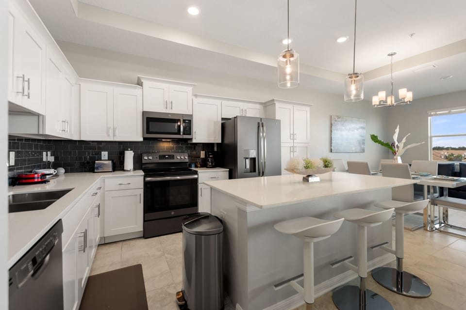 The kitchen is fully-equipped with modern features and with a bar height seating at the counter for 3