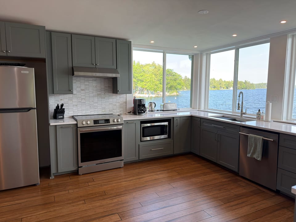 Full kitchen setup complete with stove, oven, refrigerator, and dishwasher