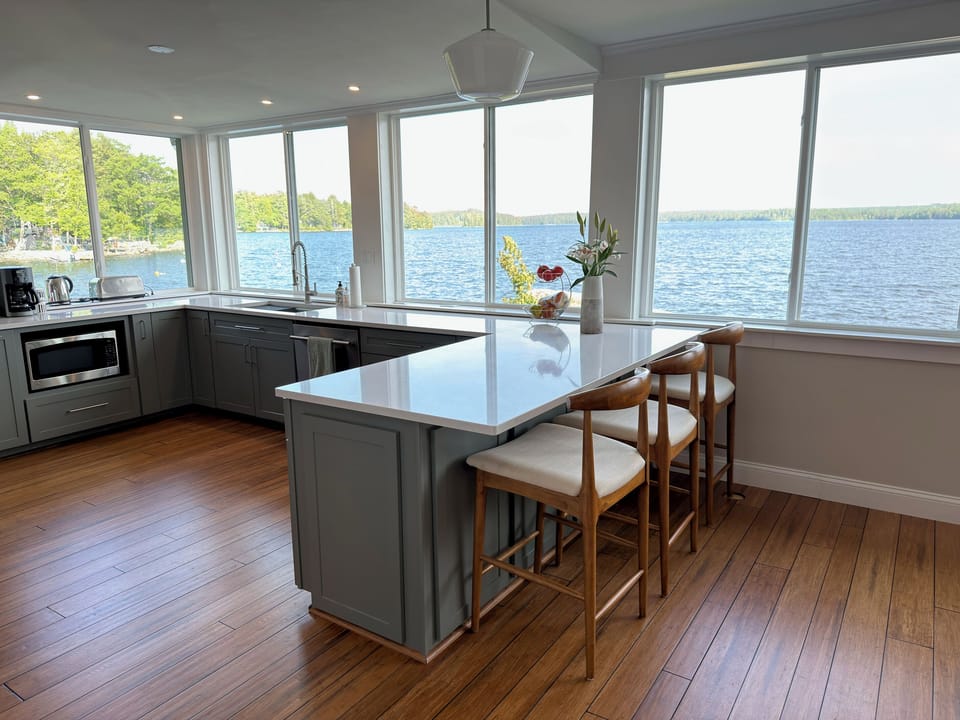 Fully equipped modern kitchen with a quartz island overlooking the water