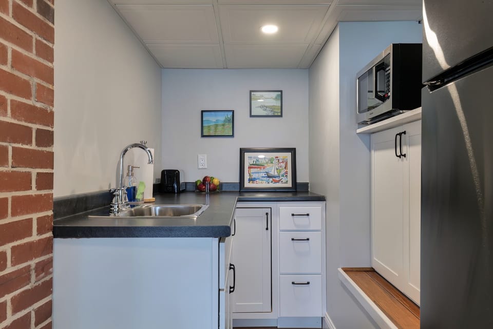 Convenient lower-level kitchenette with sink, mini-fridge, and microwave