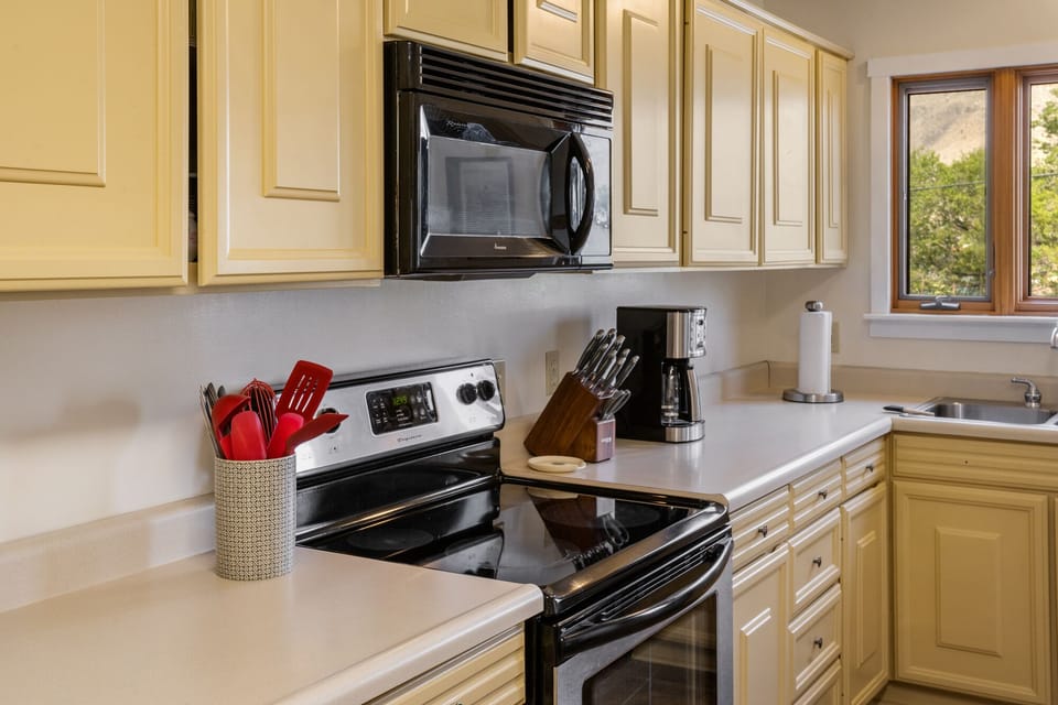 Full kitchen with drip coffee maker.
