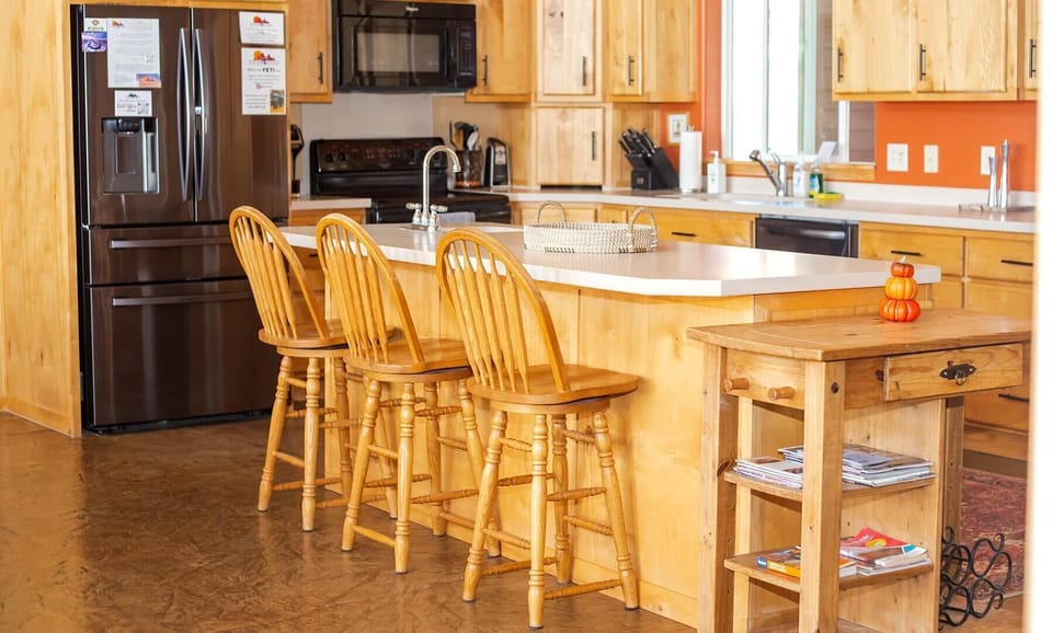 The kitchen has ample counter space and seating for 3 at the breakfast bar.