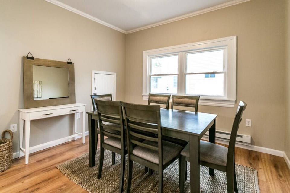 A cozy dining room with a wooden table and chairs, perfect for gathering with loved ones.
