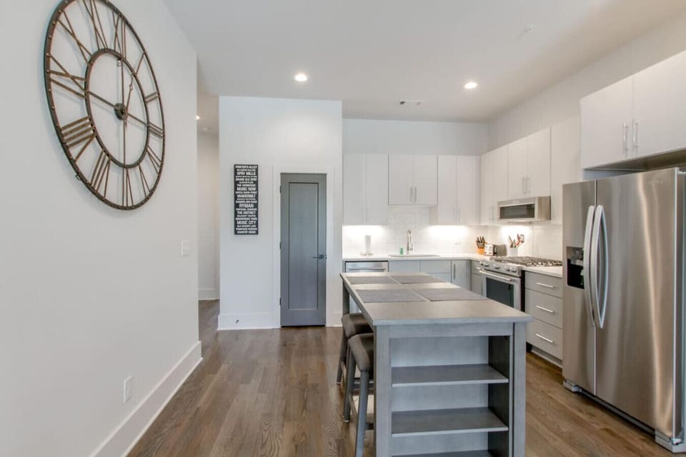 Whip up a meal at the spacious island in this bright, fully stocked kitchen.