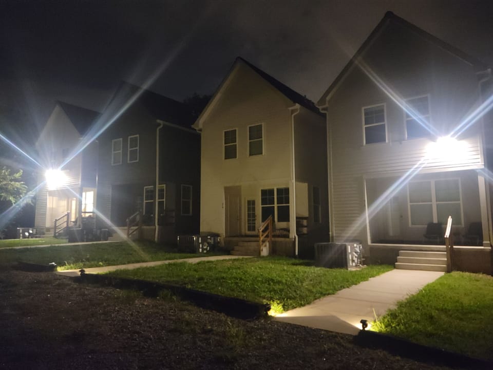 View of back porch and yard, from parking area.