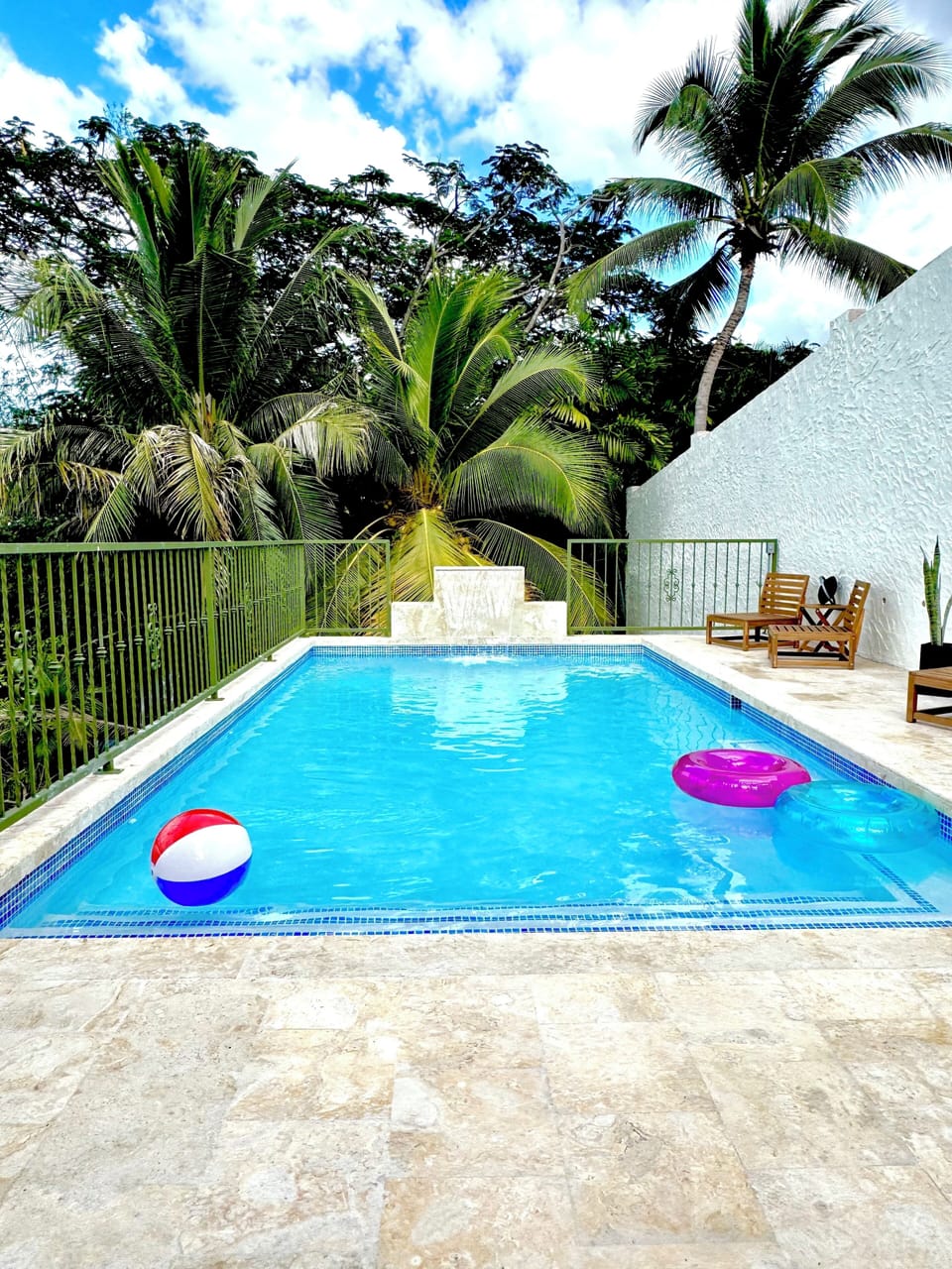 Pool area surrounded by lush landscaping in a private setting. 