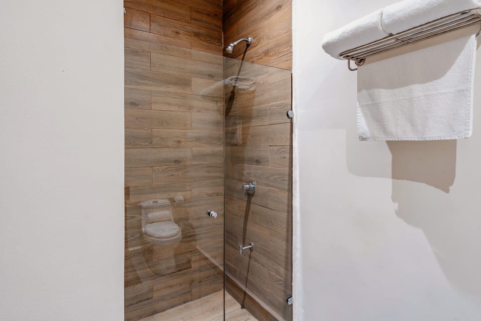 Deluxe Studio Suite | Bathroom | Shower, towels, soap, shampoo