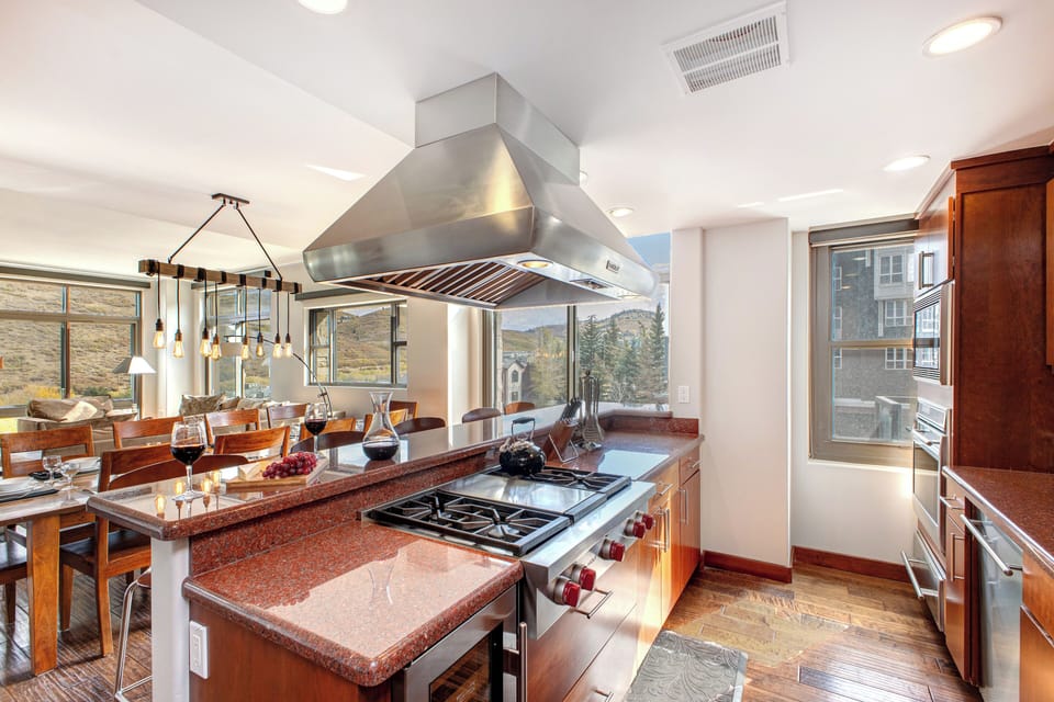 Lowell 402 kitchen island with range and stainless steel range hood.