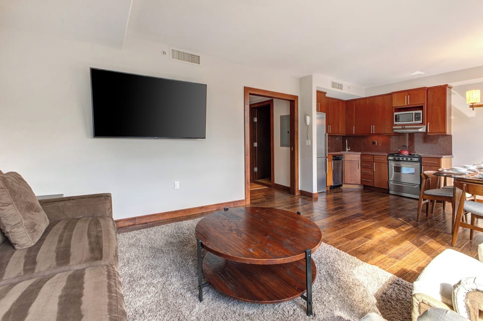 Lowell 402 living room with comfortable seating and flat screen TV.