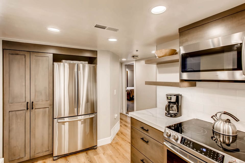 Stainless steel French door refrigerator in the fully equipped kitchen