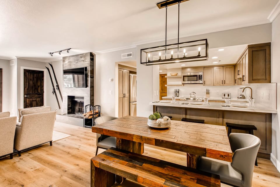 Elegant dining space with the full kitchen and living room in the background