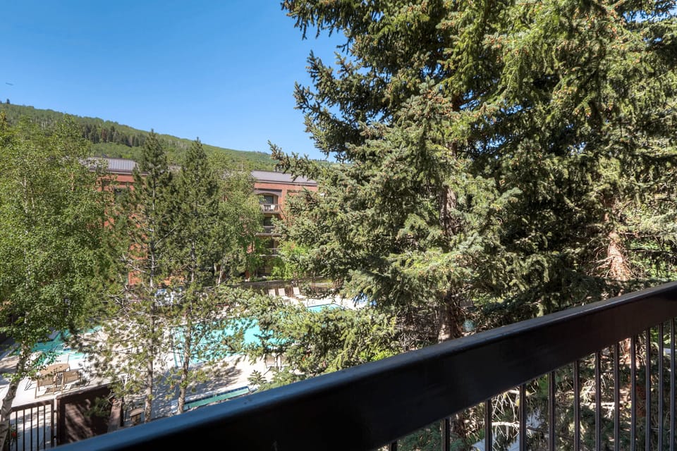 A private balcony has seating for two and views of the mountain.
