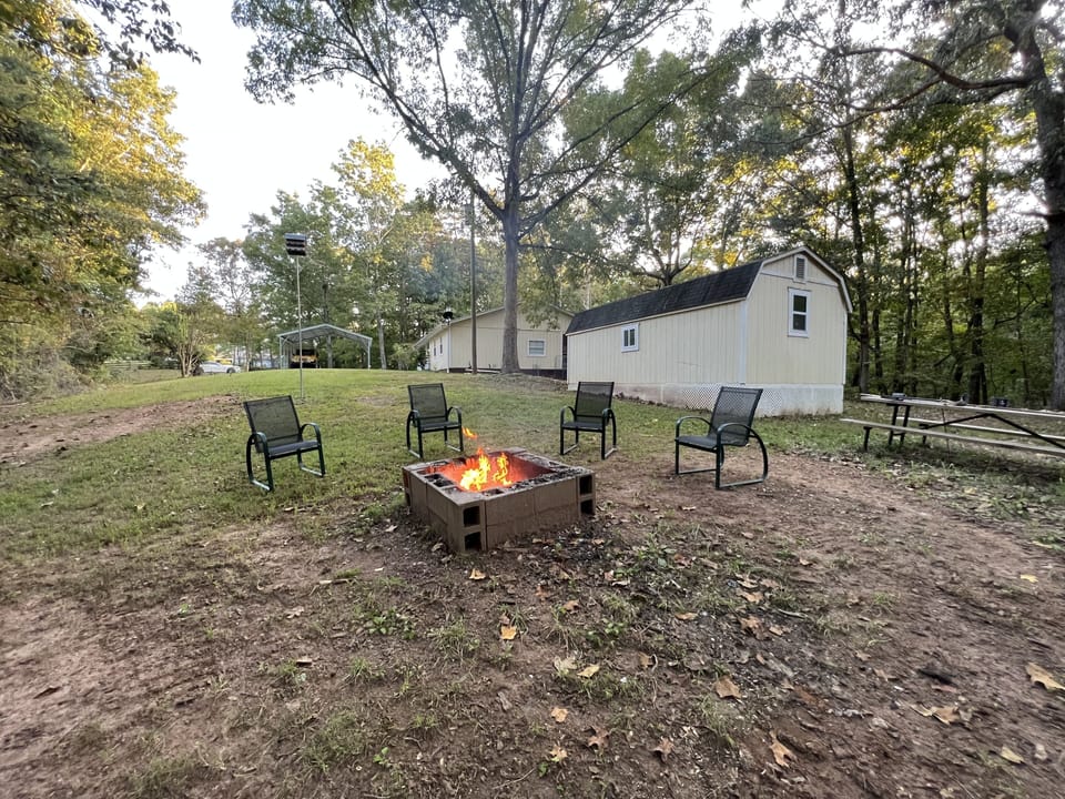 Fire pit with outdoor furniture and picnic table. 