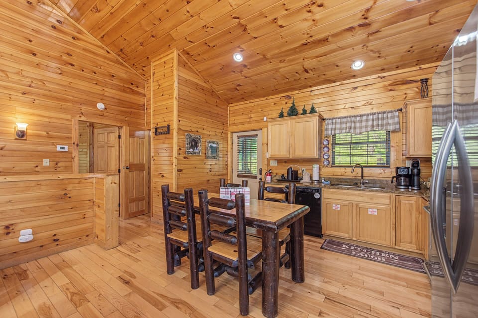 Warm wood surrounds you in this rustic kitchen where morning coffee and hearty meals become cherished cabin memories.