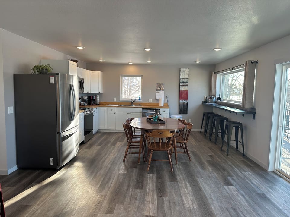 Kitchen is roomy and flooded with light. It is well equipped for cooking.