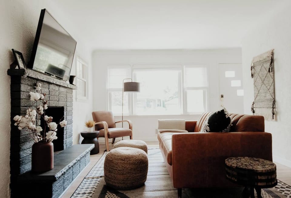 Living room with smart tv and leather couch, reading chair