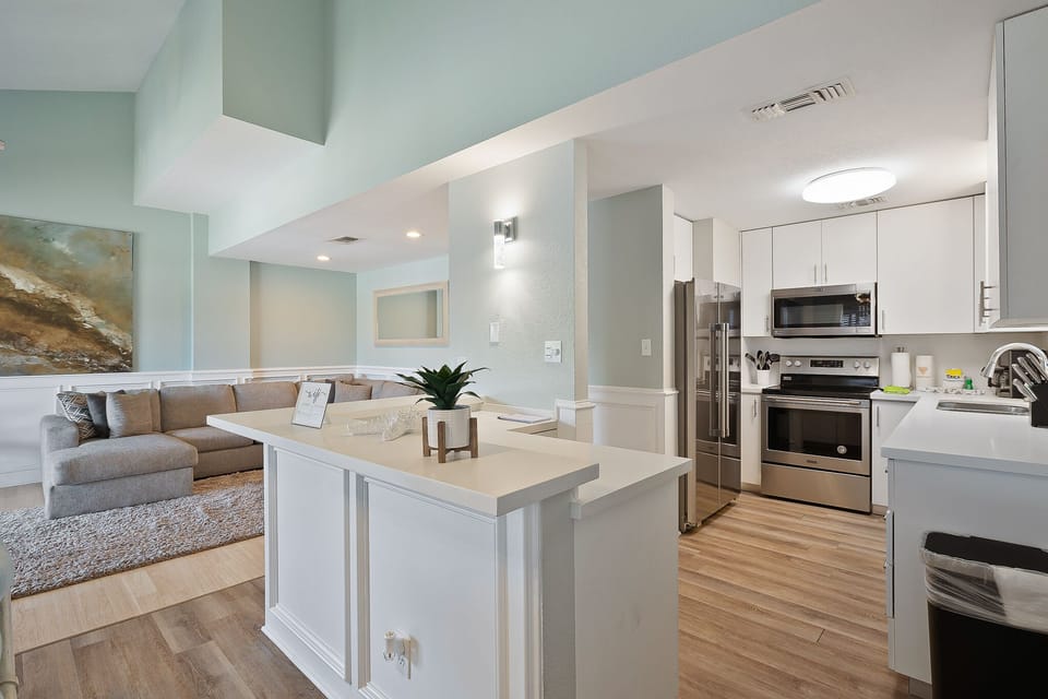 Kitchen with new stainless steel appliances & fully stocked with pots, pans, dish-ware and utensils.