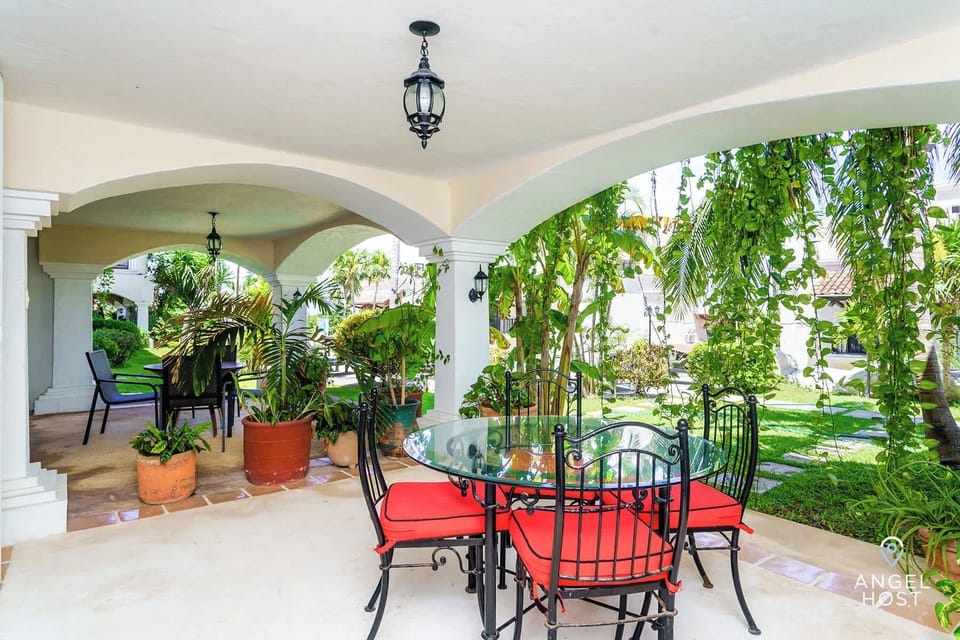 Lush tropical scenery surrounds the patio