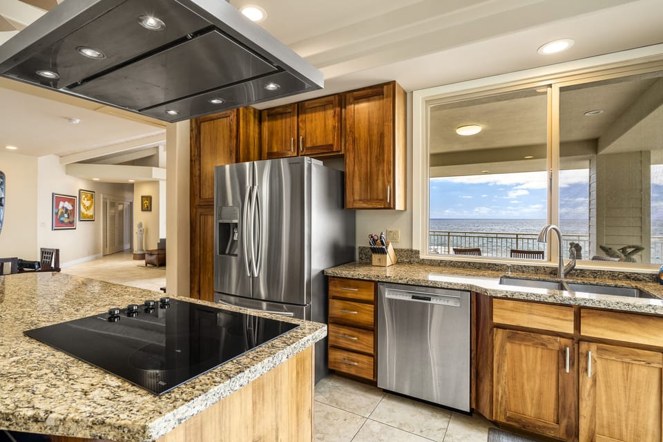 Prepare your favorite meals while enjoying company in this chef-style kitchen with island seating and coastal views.